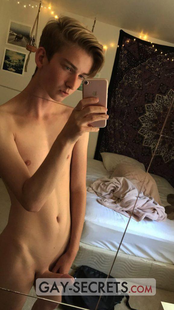 Smooth gay boy shows off his naked body in the mirror